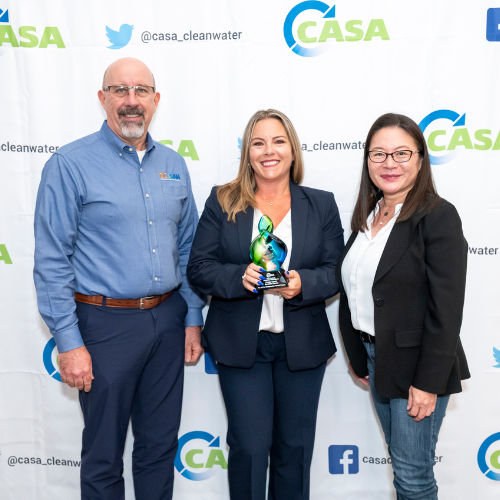 Photo of three Executive Management Team members receiving reward